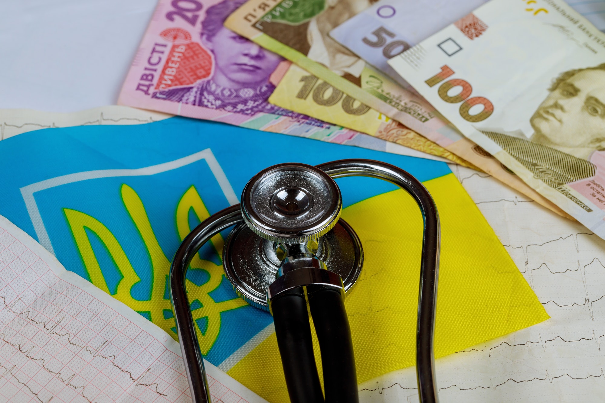 stethoscope and cardiogram with ukrainian hryvnia Ukraine flag series